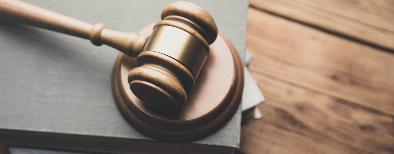 law book with a wooden judges gavel