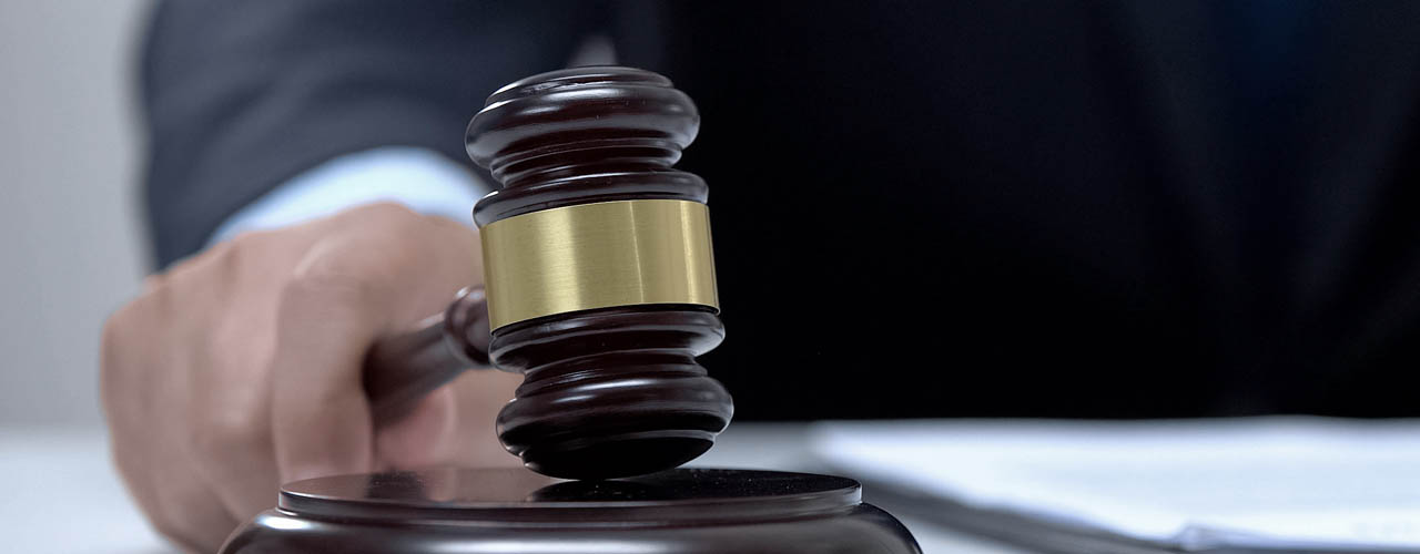 Male judge banging gavel on block, court determines sentence, pr